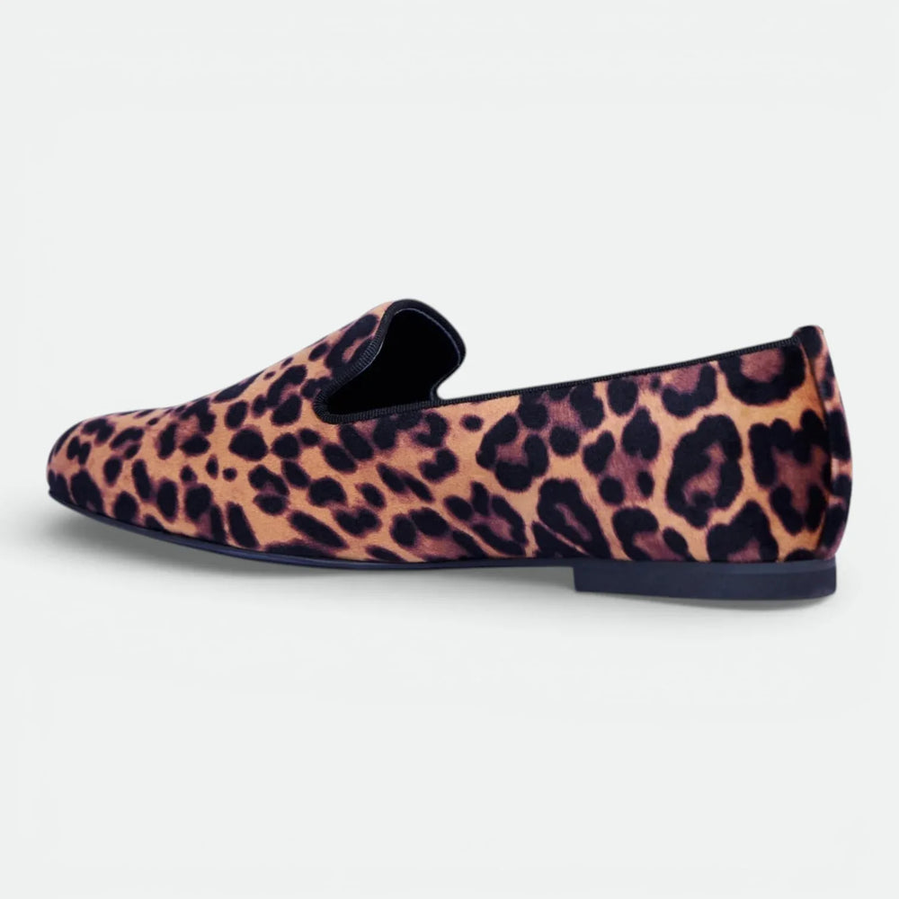 Leopard print loafer shoe with flat sole and slip-on design on white background