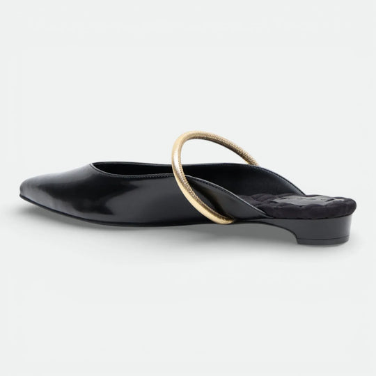Black pointed-toe mule with gold round strap and low heel on white background